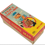Box for a mechanical toy 'Peace Corps Man' with colorful design on a white background