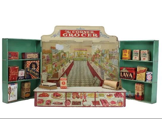 Miniature model of a grocery store with 'The Corner Grocer' sign and various products on shelves.