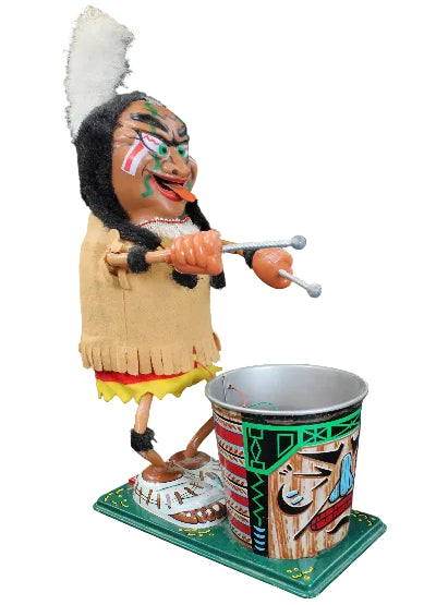 Colorful Native American figurine playing a drum with a cup on a black background