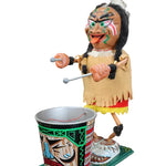 Colorful Native American dancer puppet with a cup and ball on a dark background