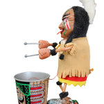 Traditional Native American puppet with headdress and drum on a dark background