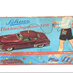Vintage Schuco toy car packaging with a red car illustration on a blue background.