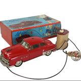 Red toy car with a pull string and its box on a white background