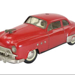 Model of a red classic car on a white background
