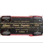 Bottom view of a Schuco toy car with branding and model number on a white background