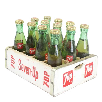 Vintage Seven-Up soda bottles in a wooden crate on a white background