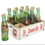 Vintage Seven-Up bottles in a wooden crate on a white background