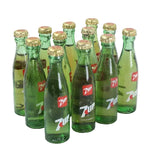 Collection of green glass bottles with gold caps on a white background