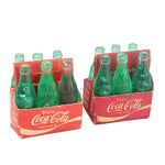 Two packs of Coca-Cola miniature bottles on a white background