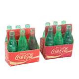 Two packs of Coca-Cola miniature bottles on a white background