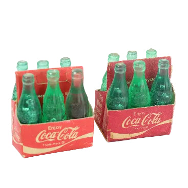Two packs of Coca-Cola miniature bottles on a white background