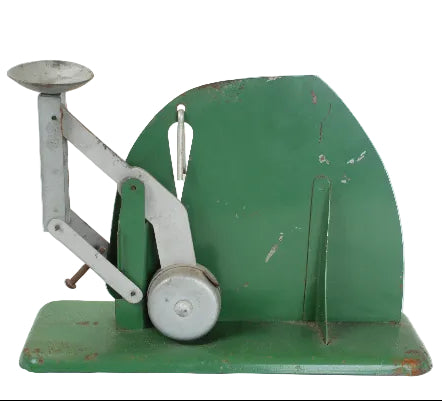 Vintage green and silver mechanical scale on a white background