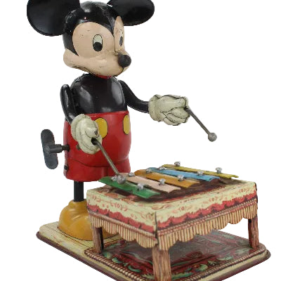 Vintage Mickey Mouse figure of playing an organ on a white background