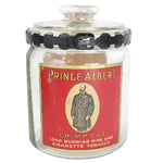 Vintage Prince Albert cigarette jar with red label on a white background