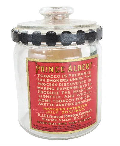 Glass jar with red label featuring text and black accents on a white background