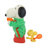 Snoopy and with a green outfit and red shoes and Woodstock on a white background