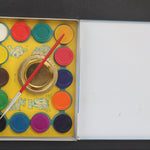 Set of Blondie watercolor paints with a brush in an open box on a dark background