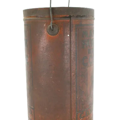 Vintage cylindrical coffee canister with metal clasp on a white background