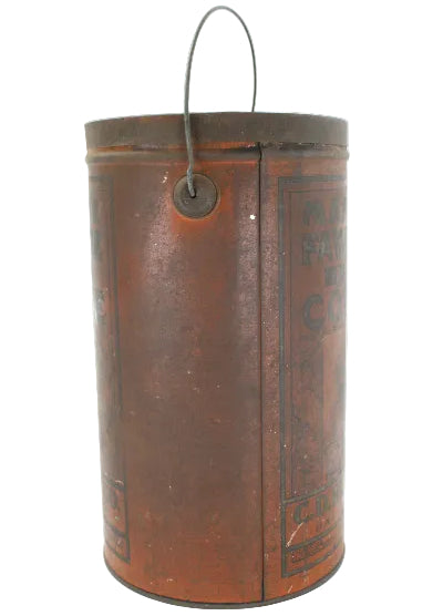 Vintage cylindrical coffee canister with metal clasp on a white background