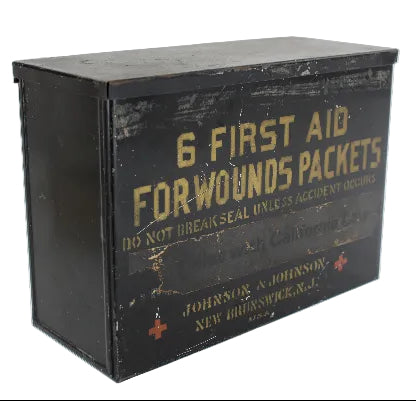 Vintage Johnson & Johnson first aid box with text on a white background