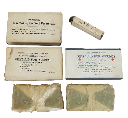 Vintage first aid kit components including boxes and bandages on a white background