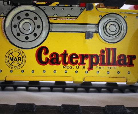 Close-up of a yellow Caterpillar product with visible Marx branding.