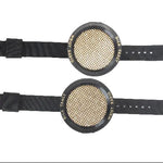 Two black wristbands with circular mesh centers on a white background