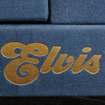 Close-up of 'Elvis' logo on a blue background