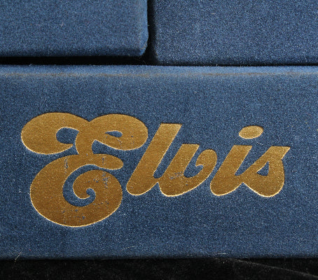 Close-up of 'Elvis' logo on a blue background