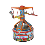 A vintage toy carousel or spinning ride with colorful painted metal details, photographed against a plain white studio background.