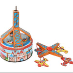 Vintage tin toy set featuring a colorful carousel tower and three matching toy airplanes on a plain white background.