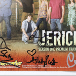 An autographed Jericho Season One trading card from Inkworks Studios, featuring the cast on the front with signatures in black, blue, and white marker across the lower portion.