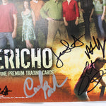 A close-up of a signed Jericho trading card featuring cast members from the television show, with multiple autograph signatures across the front. The card is photographed against a plain white background.