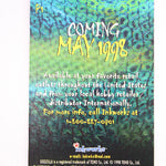 A rectangular printed card or cover with a textured green and blue surface, featuring vertical text including 'Coming May 1998' and smaller text about availability. The card is photographed against a plain white background.