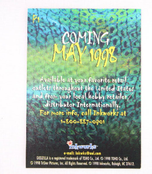 A rectangular printed card or cover with a textured green and blue surface, featuring vertical text including 'Coming May 1998' and smaller text about availability. The card is photographed against a plain white background.