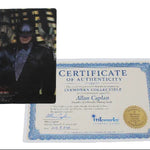 A Batman collectible card featuring Batman in a dark suit, displayed next to its blue and white Certificate of Authenticity from Allan Caplan for Inkworks Collectible.