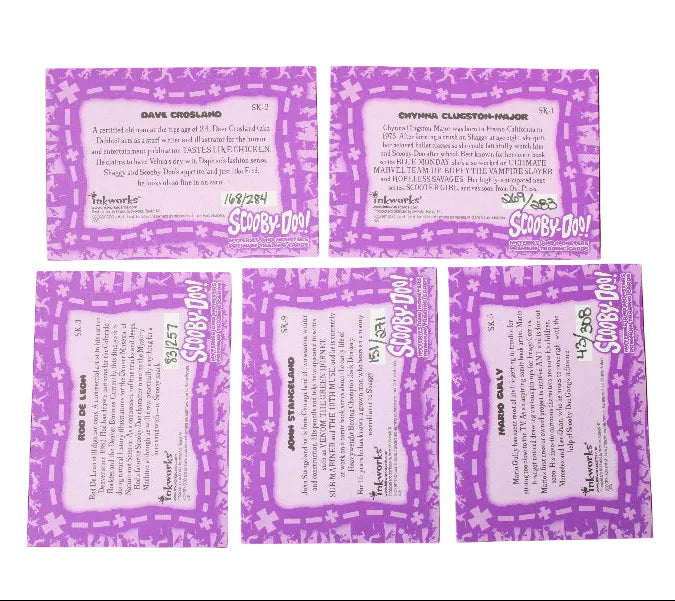 Five purple and white Scooby-Doo! trivia cards arranged on a dark gray background, showing both front and back designs.